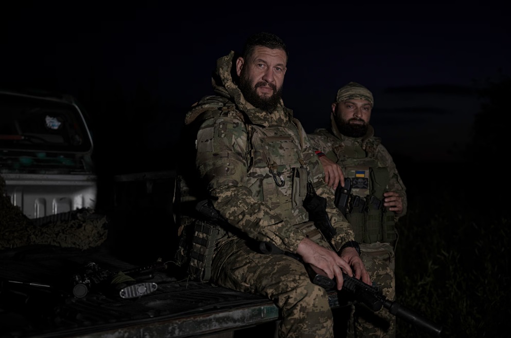 Андрій Щербина, 42 роки, та Олег Кушнеров, 36 років, сидять у кузові своєї вантажівки після повернення із завдання під Вовчанськом 27 червня.